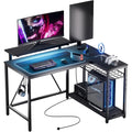 Bestier Gaming Desk With Power Outlets, 42" L-Shaped Computer Desk With Led Lights, Desk With Reversible Storage Shelves & Hooks For Small Spaces, Bedrooms & Offices, Black Carbon Fiber